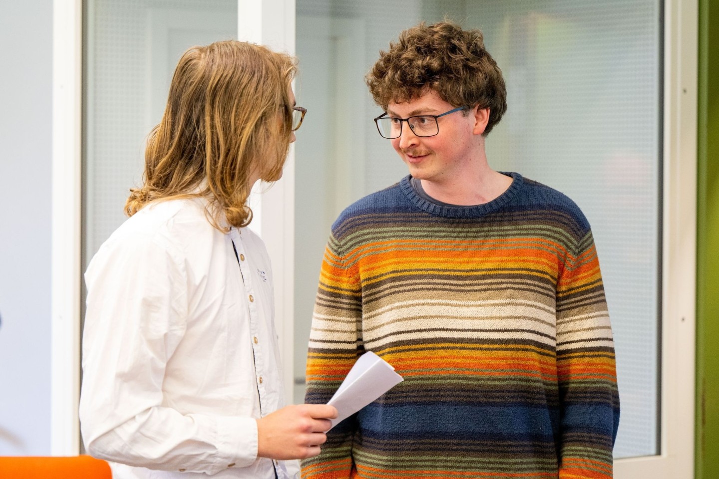 Die angeklagten Klimaaktivisten Lukas Popp (l) und Simon Lachner unterhalten sich vor dem Prozessauftakt.